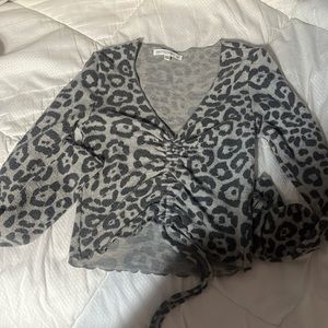 This is a soft material, long sleeve cropped shirt that ties in the front.